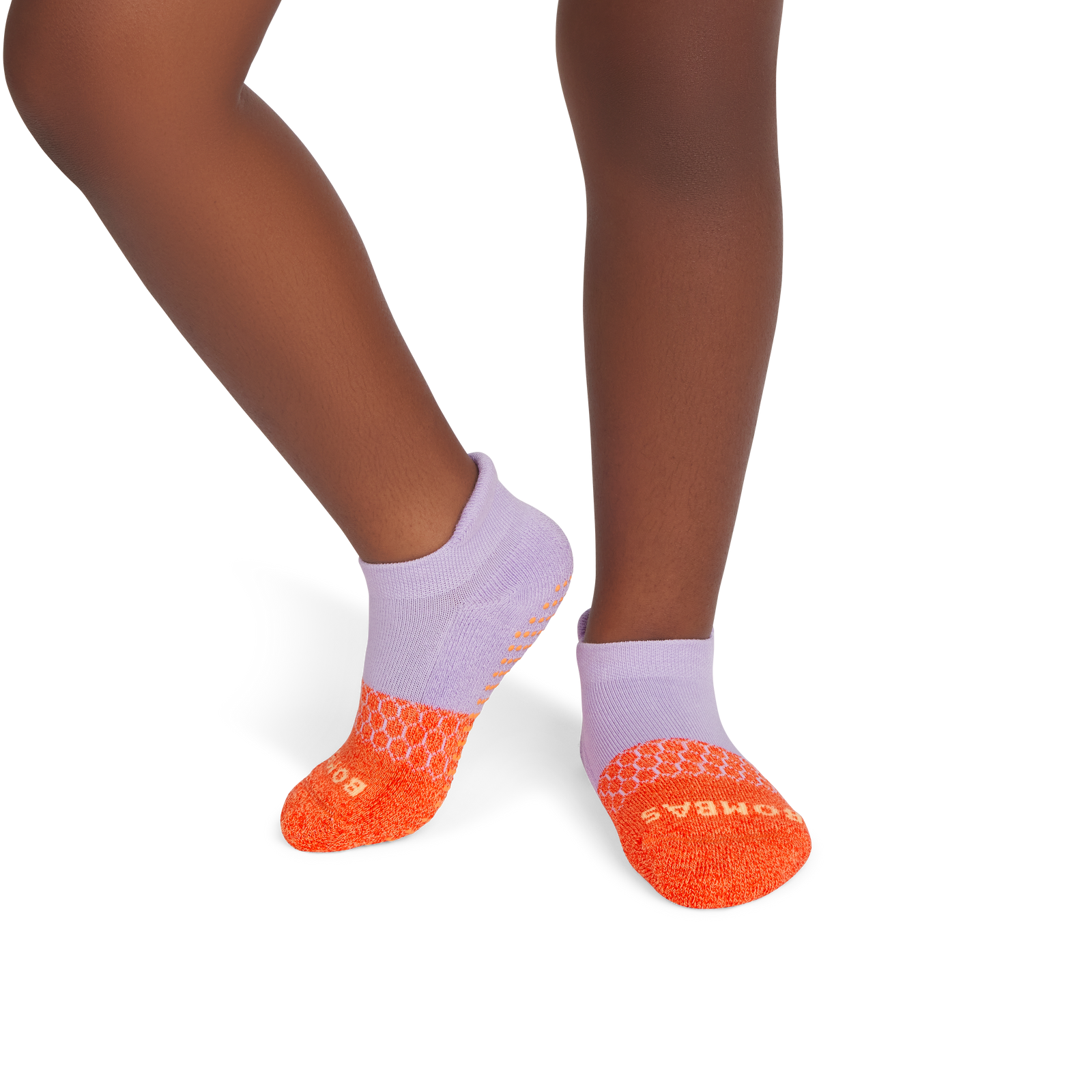 official-bombas::9824-brightcantaloupe-softlavender-junior-unisex-onmodel-2-transparent.png